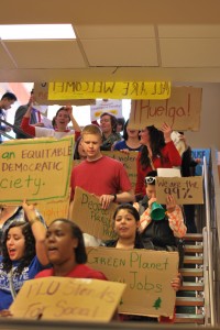Students march through Anderson University Center as part of the International Workers' Day protest at PLU on Wednesday morning.  They hold cardboard signs made by members of the student group Students of the Left and shout cheers such as "What's disgusting? Union busting!"