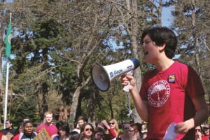 Junior Lillian Ferraz leads a call-and-response chant to a crowd of approximately 50 students and faculty members during the International Workers Day protest in Red Square on May 1.  Her pin has the name of the union PLU contingent faculty members are trying to join. 