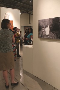 A woman studies the photograph by senior Jaeda Reed. REed specializes in photography and featured a number of pieces in "Unfiltered."