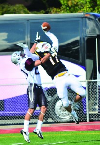 Kyle Warner, junior, snags a pass thrown by quarterback Dalton Ritchey. Warner finished the day with 137 receiving yards.