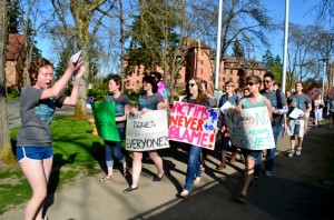 Sophomore Audrey Lewis leads participants in "radical cheers" against sexual assault as they march around campus at the events Take Back the Ngiht and Walk a Mile in Her Shoes on April 25. 