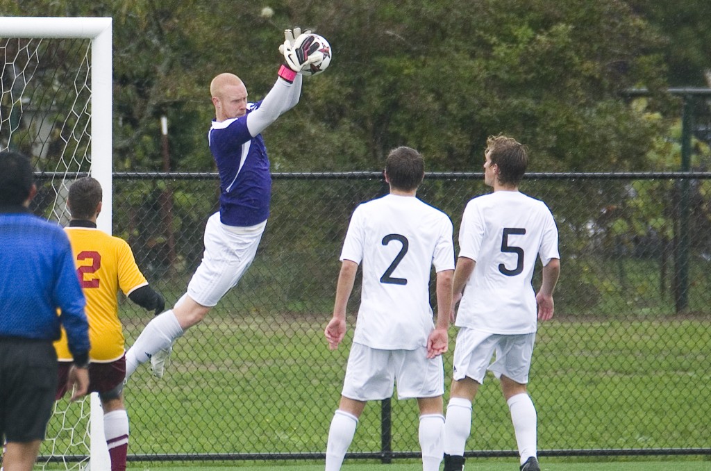 Joe Rayburn leaps off of the ground to secure a shot against Willamette on Sept. 29. Rayburn has won numerous accolades in his PLU career. One of those accolades came in 2011, when Rayburn was named as a second team All-Northwest Conference goalkeeper. Photo by Jesse Major.
