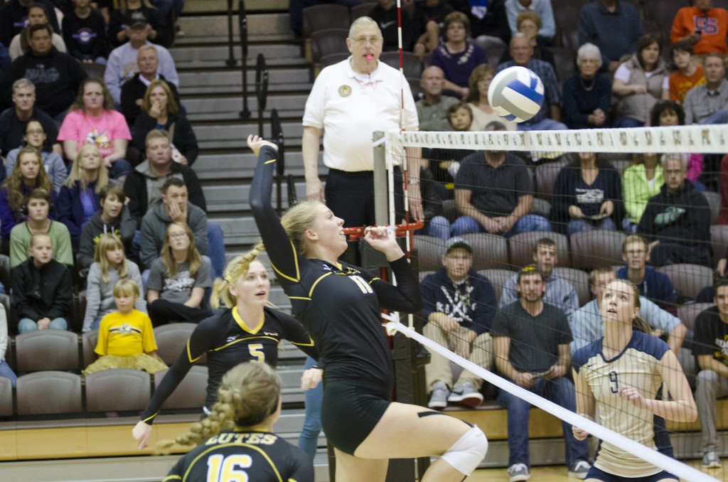 Amy Wooten, a junior, kills a ball against George Fox Friday night. Wooten finished the match with 12 kills. Photo by Jesse Major.