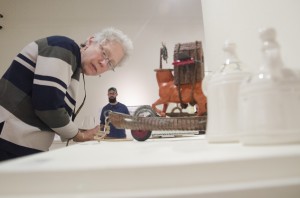 Peggy Vance, senior administrative assistant, looks closely at Spencer Ebbinga's piece titled When I was a Kid in the Faculty Exhibition in the University Gallery on Feb. 5. The gallery is open until March 5.