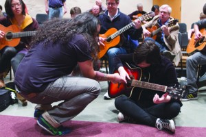 Flamenco guitarist Eric Jaeger “El Comanche” teaches first-year student Elizabeth Frerking how to play Flamenco style guitar. Frerking was one of the 28 perople that attended Jaeger’s class for the Guitar Festival at PLU. Photo by Marlene Waltoft.