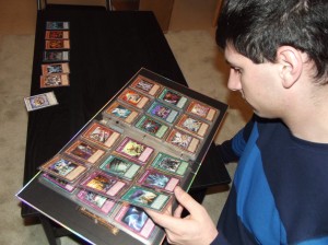 Yu-Gi-Oh! Club president Andrew Morris flips through his binder of cards. “It’s important to keep the cards in good condition to protect their value,” he said.