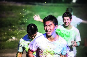 Students smile as volunteers toss colorful powder at them during the 2013 Lute Loop Color Run. LuteFit has held the non-competitive 5k run for several years now to have fun and celebrate physical fitness, but last year’s Lute Loop was the first color run in PLU’s history. Photo courtesy of Quinn Huelsbeck.