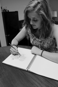 Jasper Sortun, a junior, works on a design for a screenprint for her printmaking class.