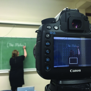 Laura Johnson, co-editor of The Matrix, writes on a chalkboard for inspiration for The Matrix. Photo by Hai Doan.