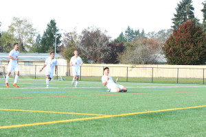 Photo by Bailey Plumb: Sophomore Eddie Na (9) slides celebrating his second goal at the 58th minute. 