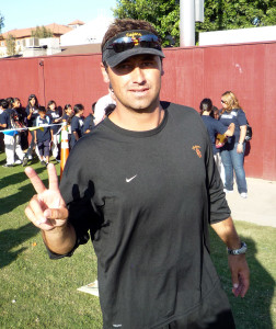 Steve Sarkisian making the "V for Victory" sign at a USC practice