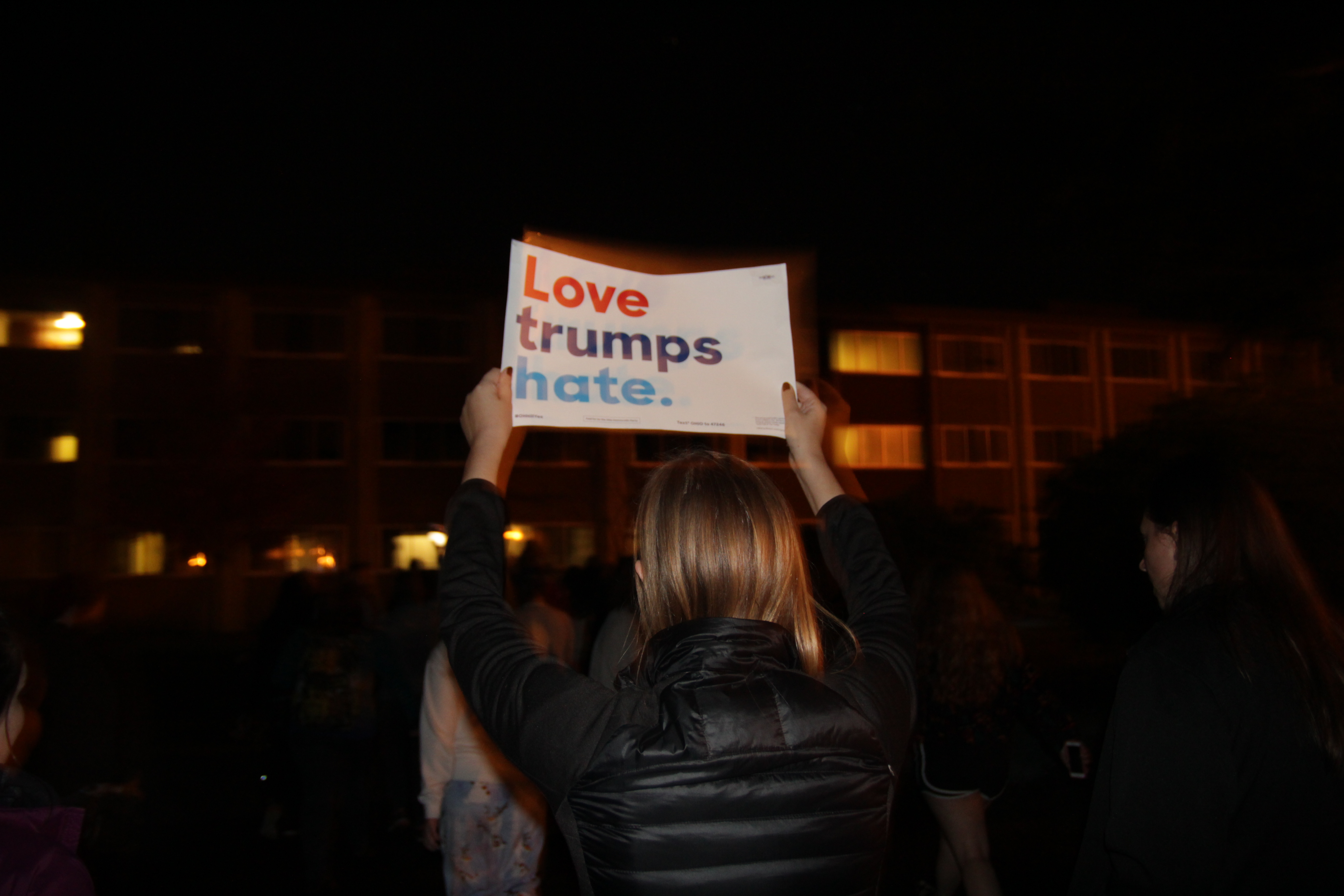 Photo by Oliver Johnson Protester carries "Love trumps hate" sign.